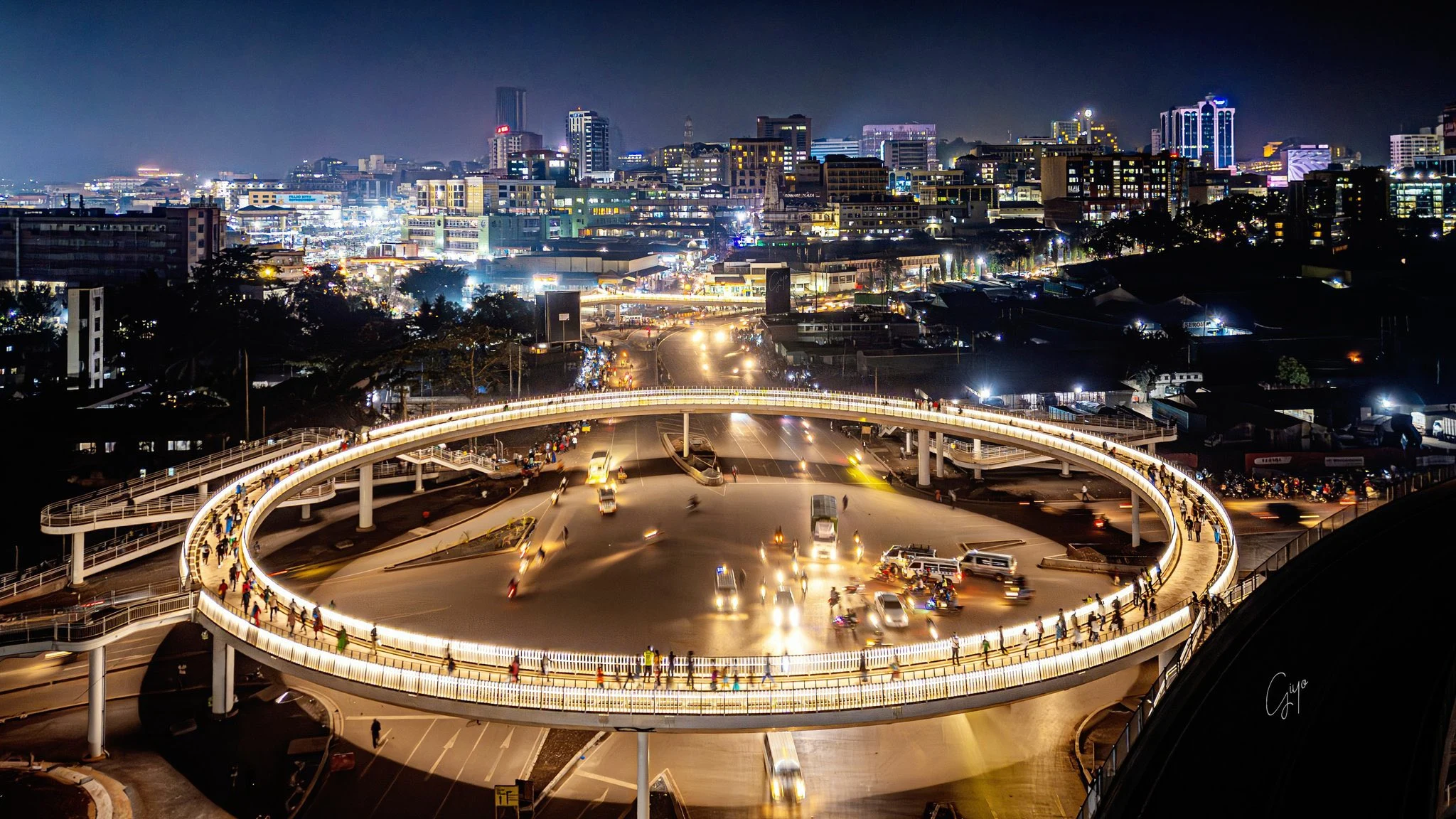 Kampala skyline and an illuminated pedestrian bridge at night