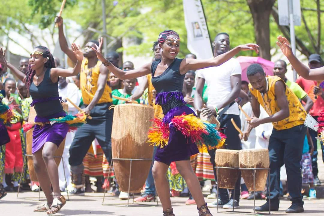 Cultural dancers and drummers performing outdoors